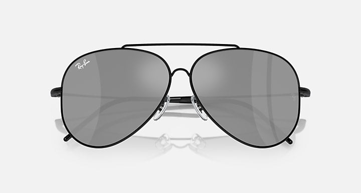 Ray-Ban aviator sunglasses with dark grey lenses and black frame, close front view.