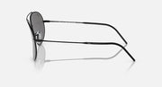Ray-Ban aviator sunglasses with dark grey lenses and black frame, temple side view.