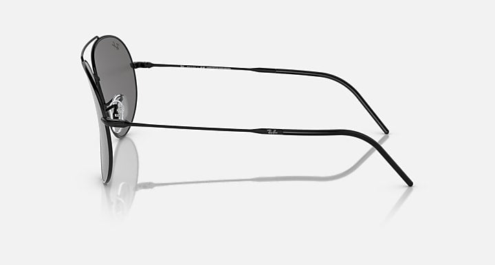 Ray-Ban aviator sunglasses with dark grey lenses and black frame, temple side view.
