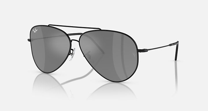 Ray-Ban aviator sunglasses with dark grey lenses and black frame, side view.