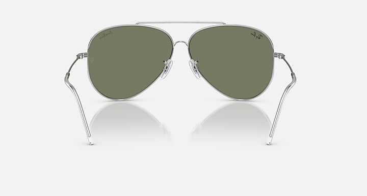 Aviator sunglasses with olive green lenses and silver metal frame, front view