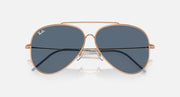 Ray-Ban aviator sunglasses with rose gold frame and dark blue lenses, centered bridge