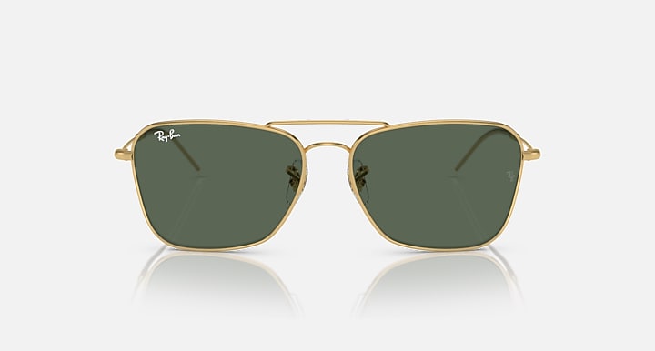 Ray-Ban Caravan Reverse sunglasses with dark green lenses and gold-tone frame, angled front.