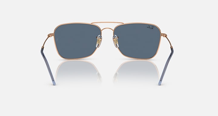 Caravan Reverse sunglasses with rose gold rims, blue temples, and dark blue lenses