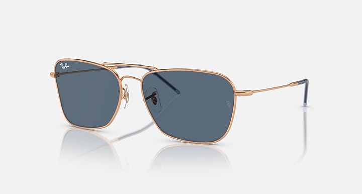 Caravan Reverse sunglasses with rose gold frames and dark blue rectangular lenses
