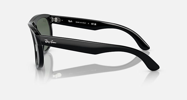 Ray-Ban sunglasses with black frame and dark lenses, side profile with logo on temple.