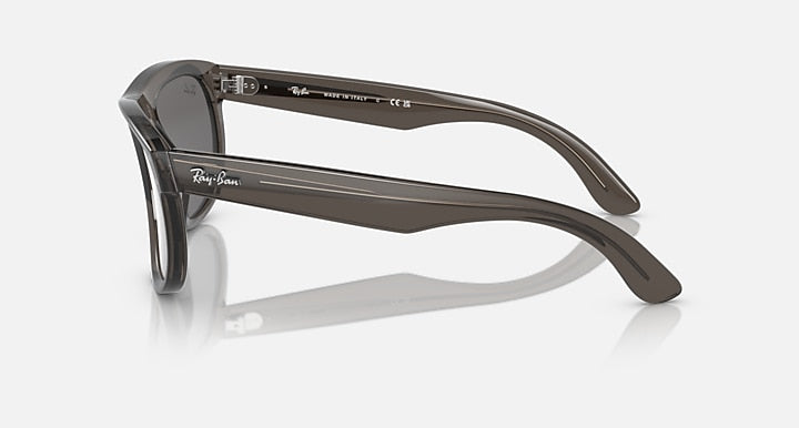 Ray-Ban sunglasses with brown frame and grey lenses, side profile.