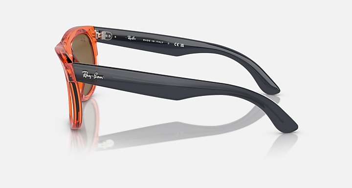 Ray-Ban Wayfarer Reverse sunglasses, orange-and-black frame with brown lenses, side view