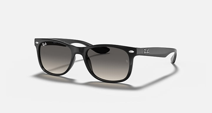 Ray-Ban Junior wayfarer sunglasses, glossy black frame with dark lenses, angled view