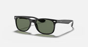 Green-tinted dark sunglasses with black frame, kid-sized Wayfarer shape