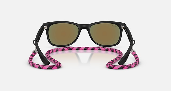 Ray-Ban Junior Wayfarer sunglasses with pink patterned strap and brown tinted lenses.