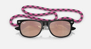 Ray-Ban Junior Wayfarer sunglasses, top view; black frame, pink patterned strap, brown lenses.