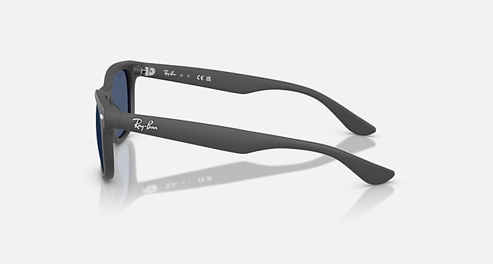 Ray-Ban Junior Wayfarer sunglasses, side view; dark frame with blue tinted lenses.