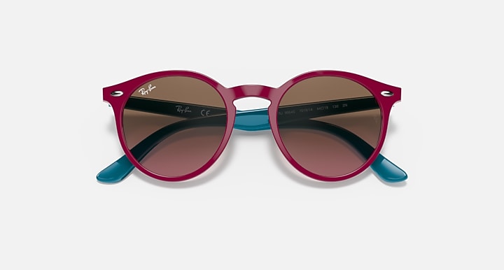 Burgundy round sunglasses with dark gradient lenses and teal temple tips.