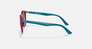 Teal round sunglasses with magenta temple tips, shown from the side.