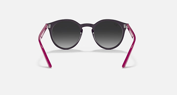 Magenta round sunglasses with dark lenses and clear accents at the temples.