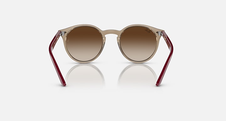 Ray-Ban round sunglasses with light frame and maroon arms, brown lenses