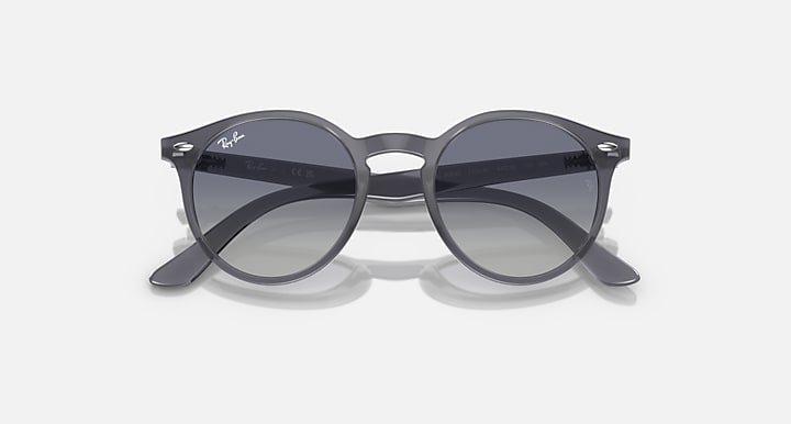 Ray-Ban RJ9064S round sunglasses, angled view, with dark lenses and grey frames
