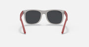 Sunglasses with gray frames and dark lenses, red rubber arms, and metal accents