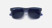 Sunglasses with dark blue frames and dark lenses, with subtle clear edges on the rims