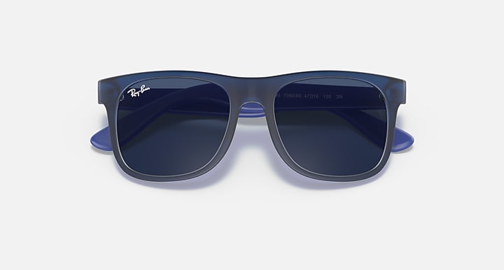 Sunglasses with dark blue frames and dark lenses, with subtle clear edges on the rims