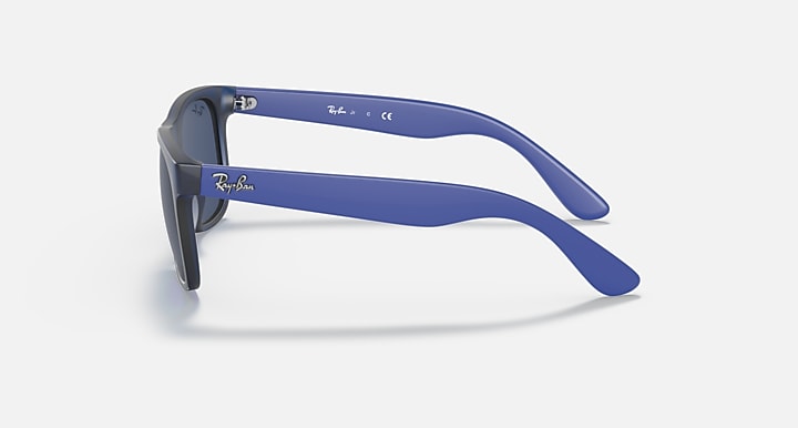 Sunglasses with blue frames and dark lenses, with blue rubber temples and side arms