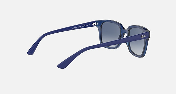Sunglasses with blue frame and dark blue gradient lenses, angled side view