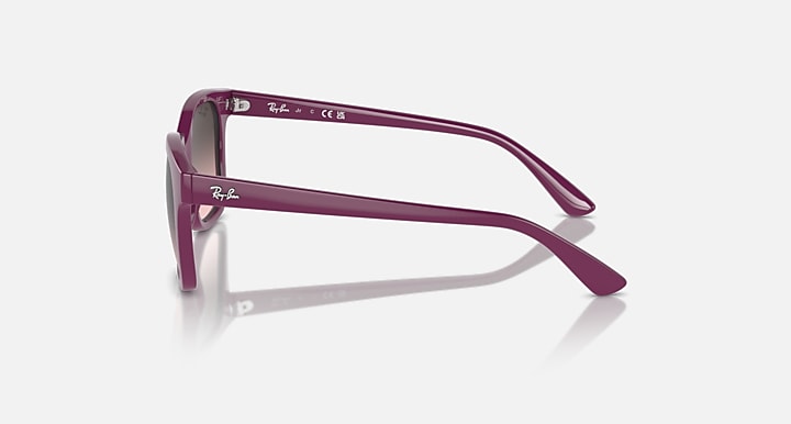 Sunglasses with cherry/pink frame, side profile, gradient lenses