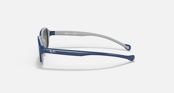 Blue kids sunglasses side profile with green-tinted lenses and white-gray frame