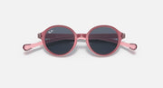 Ray-Ban round sunglasses with rose-pink frame and dark lenses.
