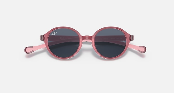 Ray-Ban round sunglasses with rose-pink frame and dark lenses.