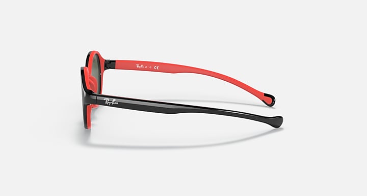 Ray-Ban sunglasses side view with red frame, black temple arms, and dark lenses