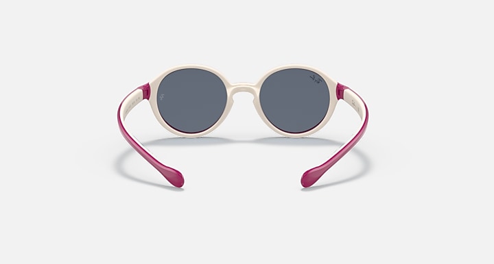Ray-Ban round sunglasses with dark gray lenses, cream frame, and magenta arms