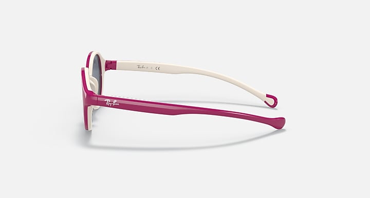 Ray-Ban sunglasses side view with light beige arms, magenta frame, and dark lenses