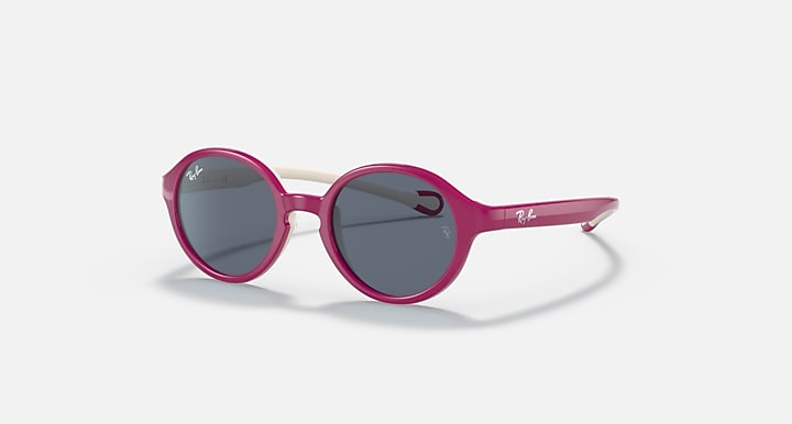 Ray-Ban round sunglasses with dark blue lenses, pink frame, and light pink arms