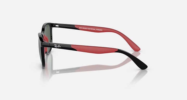 Black and red Ray-Ban sunglasses, side profile showing tapered arms and dark lenses