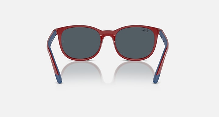 Red sunglasses with dark gray lenses and blue accents on the temples