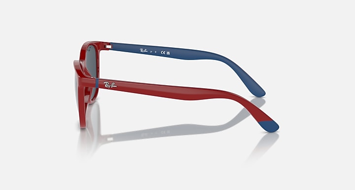 Red and blue sunglasses side profile with dark lenses