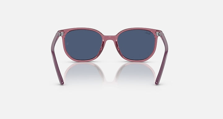 Ray-Ban Elliot RJ9097S sunglasses, symmetrical front, transparent pink frame with dark blue lenses