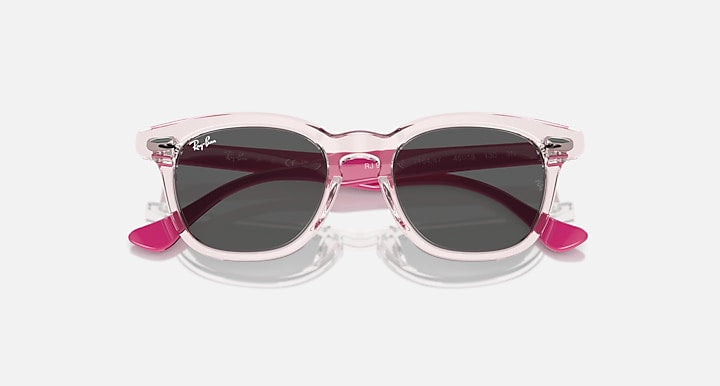 Ray-Ban RJ9098SF sunglasses front view with pink translucent frames and dark lenses
