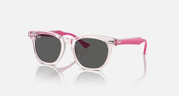 Ray-Ban RJ9098SF sunglasses with pink translucent frames and dark charcoal lenses