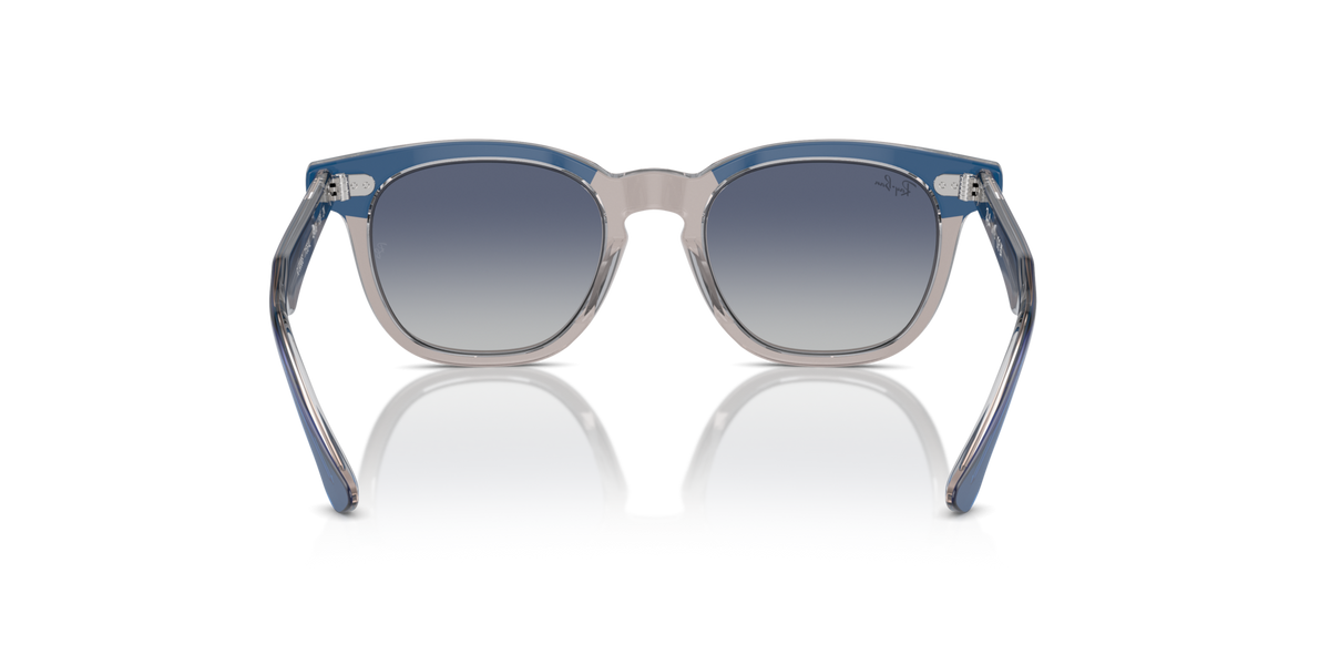 Ray-Ban kids sunglasses with blue frame and dark gradient lenses, angled front view.