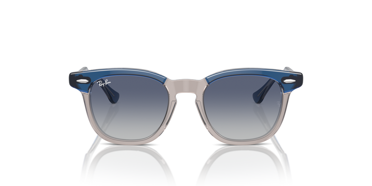 Ray-Ban kids sunglasses with blue translucent frame and round dark lenses, front view.