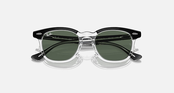 Ray-Ban RJ9098S sunglasses with transparent frame and dark green lenses, angled front view