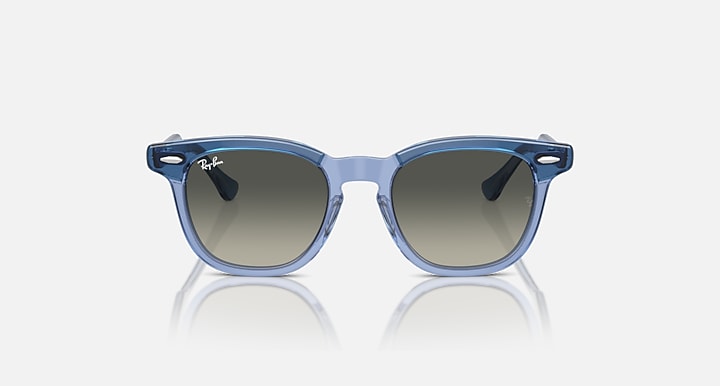 Ray-Ban RJ9098S sunglasses with light blue transparent frame and gradient blue lenses, front view