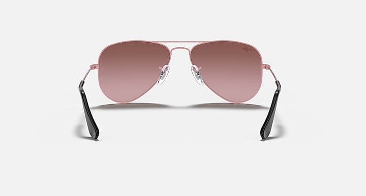 Rose gold aviator sunglasses with pink lenses and dark angled arms