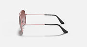 Rose gold aviator sunglasses, side view with dark arms and pink tinted lenses