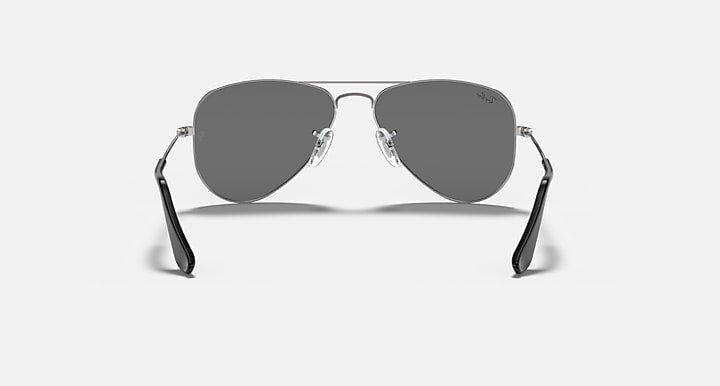 Aviator sunglasses with dark gray lenses and silver-tone metal frame, curved nose bridge