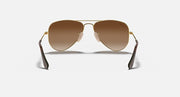 Ray-Ban aviator sunglasses with gold metal frame and brown gradient lenses, straight-on