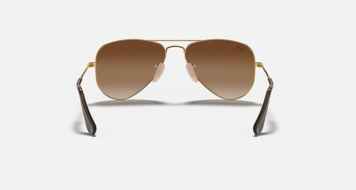 Ray-Ban aviator sunglasses with gold metal frame and brown gradient lenses, straight-on